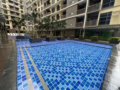 a swimming pool in the middle of a building at Spacious 2BR Luxury Suite across Okada, Airport in Manila