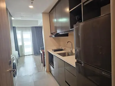 a kitchen with a stainless steel refrigerator and a sink at The Residences at BCCT by Stays PH Cozy retreat with hotel-style comforts and convenience, best location in BGC in Manila