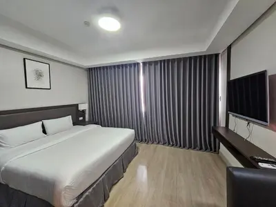 a hotel room with a bed and a television at The Residences at BCCT by Stays PH Cozy retreat with hotel-style comforts and convenience, best location in BGC in Manila