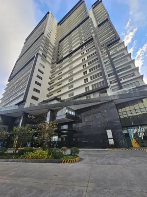 a large building with a sign in front of it at The Residences at BCCT by Stays PH Cozy retreat with hotel-style comforts and convenience, best location in BGC in Manila