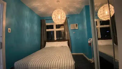a small room with a bed and a mirror at The Radiance Manila in Manila