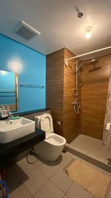 a bathroom with a toilet and a sink and a shower at The Radiance Manila in Manila