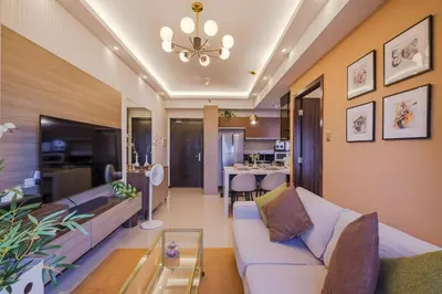 a living room with a couch and a table at EC Suites Modern 1Br Suite w Balcony in Pasay in Manila