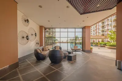 a living room with a couch and a large window at EC Suites Modern 1Br Suite w Balcony in Pasay in Manila