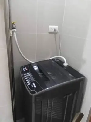 a television with a cord plugged into a wall at Romeotwopalmtreevilla in Manila