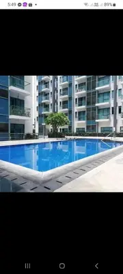 a large swimming pool in front of a building at Romeotwopalmtreevilla in Manila