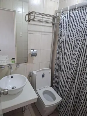 a bathroom with a toilet and a sink and a shower at Modern Studio Birch Tower Near Malls & Nightlife in Manila