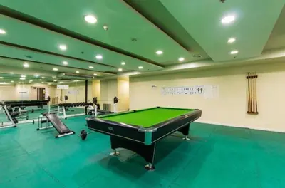 a billiard room with a pool table and several chairs at Modern Studio Birch Tower Near Malls & Nightlife in Manila