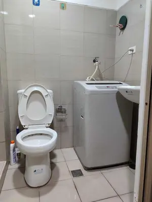 a small bathroom with a toilet and a sink at Staycation at Shore 2 Residences Tower 1 Near Moa, PICC, STARCITY, WORLD TRADE, SMX, MOA ARENA & NAIA 123 in Manila