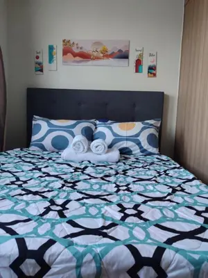 a bedroom with a bed with towels on it at Staycation at Shore 2 Residences Tower 1 Near Moa, PICC, STARCITY, WORLD TRADE, SMX, MOA ARENA & NAIA 123 in Manila