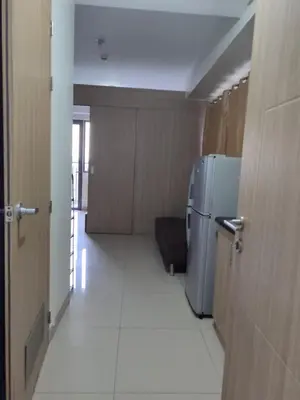 a hallway with a refrigerator in a room at Staycation at Shore 2 Residences Tower 1 Near Moa, PICC, STARCITY, WORLD TRADE, SMX, MOA ARENA & NAIA 123 in Manila