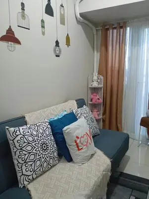 a couch with pillows on it in a living room at CozyStay by MA-Coast Residences in Manila