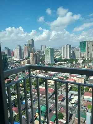 a view of a city from a balcony at CozyStay by MA-Coast Residences in Manila