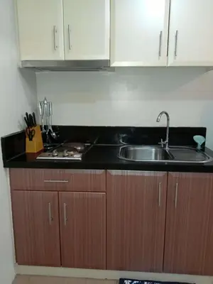 a kitchen with a sink and a counter top at Jace Oasis in Manila