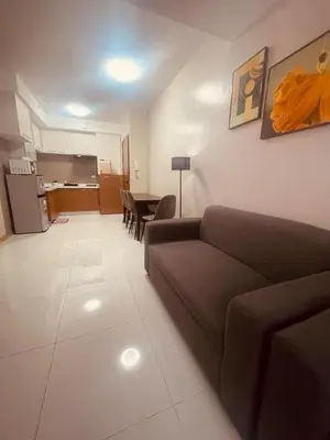 a living room with a couch and a table at Cozy Studio Unit located at serene area in Manila