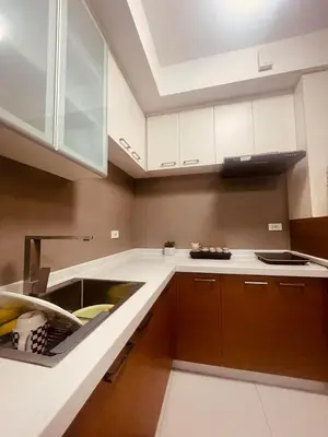 a kitchen with a sink and a counter top at Cozy Studio Unit located at serene area in Manila