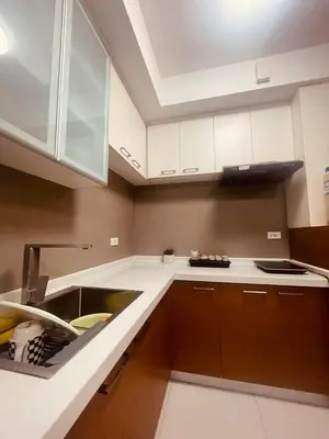 a kitchen with a sink and a counter top at Cozy Studio Unit located at serene area in Manila