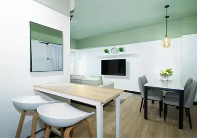 a kitchen and dining room with a table and chairs at Villa Verde, Tivoli Garden Residences in Manila