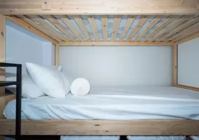 a bed with white pillows and a wooden ceiling at Villa Verde, Tivoli Garden Residences in Manila