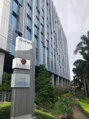 a sign in front of a tall building at South Sanctuary in Manila