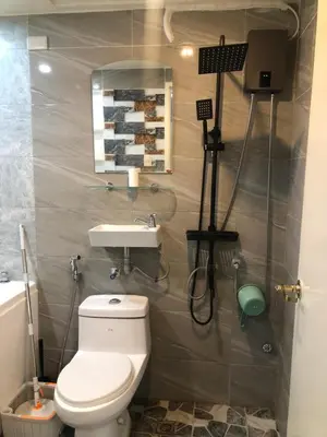 a bathroom with a toilet and a sink at South Sanctuary in Manila