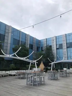 a building with tables and chairs in front of a building at South Sanctuary in Manila