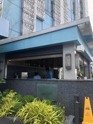 two people sitting at a restaurant in a building at South Sanctuary in Manila