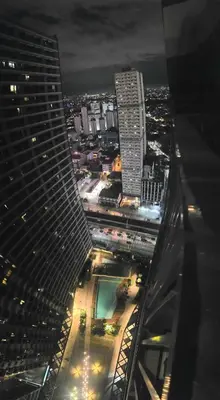 a view of a city at night from a skyscraper at CityHomeStay in Manila