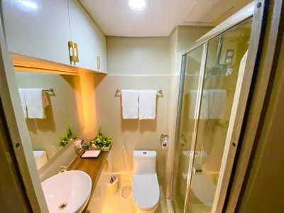 a bathroom with a toilet and a sink and a shower at CityHomeStay in Manila