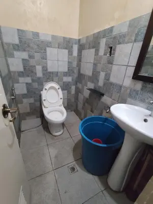 a bathroom with a toilet and a sink and a bucket at TerisitaPlace - BamboRoom in Taytay