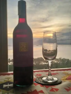 a bottle of wine sitting next to a glass at Chic Haven in Manila