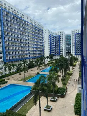 a view of the pool from the balcony of a apartment at Sea Residence Finest By Douie in Manila