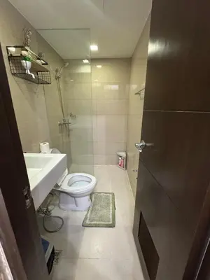 a bathroom with a toilet and a sink and a shower at Industrial Chic Studio in McKinley Hill Walk to Venice Mall in Manila