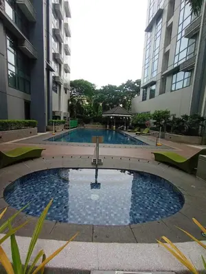 a large swimming pool in the middle of a building at Industrial Chic Studio in McKinley Hill Walk to Venice Mall in Manila