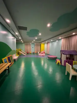 a room with a play area with chairs and tables at Industrial Chic Studio in McKinley Hill Walk to Venice Mall in Manila