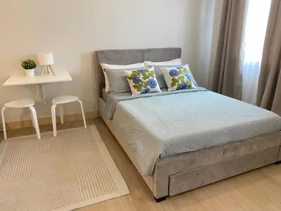 a small bedroom with a bed and two stools at Condo unit near SM City Sta Rosa unit 3 in Santa Rosa