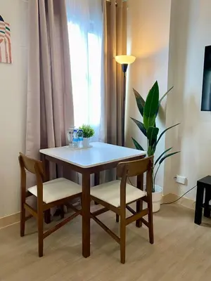 a dining room table and chairs with a window at Condo unit near SM City Sta Rosa unit 3 in Santa Rosa