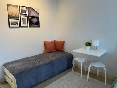a bedroom with a bed and a table and two stools at Condo unit near SM City Sta Rosa unit 3 in Santa Rosa