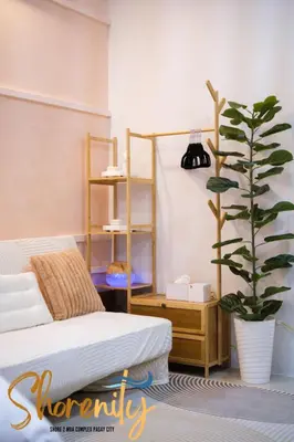 a bedroom with a bed and a potted plant at Shorenity MOA Staycation in Manila