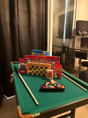 a pool table with cue balls and other toys on it at Celestial Sphere Staycation in Manila