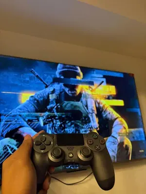 a person holding a video game controller in front of a tv at Celestial Sphere Staycation in Manila