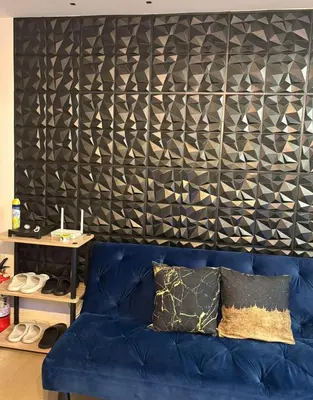 a blue couch in a living room with a black wall at Celestial Sphere Staycation in Manila