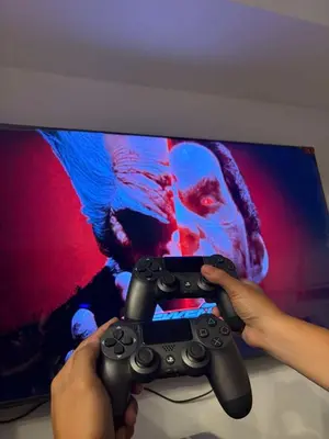 a person holding a video game controller in front of a tv at Celestial Sphere Staycation in Manila