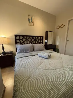 a bedroom with a large bed with a white comforter at Spacious 1BR APT near Nightlife and Business Center in Makati in Manila