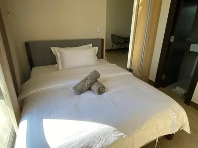 a bed with two teddy bears on top of it at 2mins to Okada near Airport & MOA with Balcony-8E in Manila