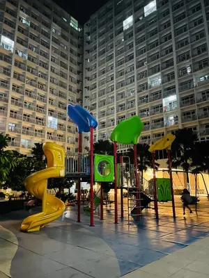 a playground with colorful equipment in front of a building at Shore 1 Condo near MOA - PLS send valid IDs of all guests after booking for guest authorization form purposes in Manila