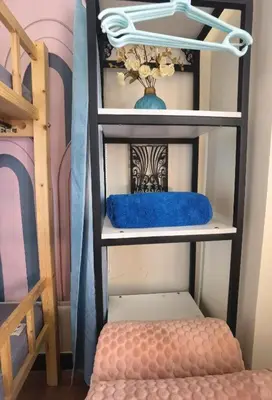 a shelf with a blue pillow on a bunk bed at Brixton Place in Manila