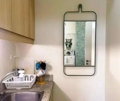 a bathroom with a sink and a mirror at Brixton Place in Manila