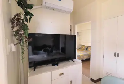 a living room with a large flat screen tv at Brixton Place in Manila