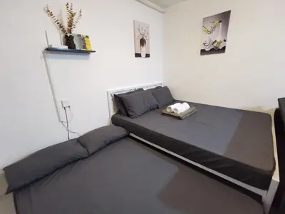 a bed in a room with a bed frame at Luna staycation Cozy Condo near Enchanted Kingdom in Santa Rosa